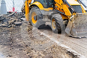 Tractor with bucket performs road works