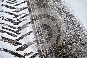 Tractor and car tracks in snow