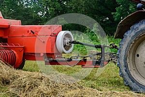 Tractor and cardan shaft for coupling equipment, tractor in the field during haymaking