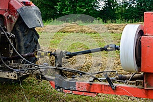 Tractor and cardan shaft for coupling equipment, tractor in the field during haymaking