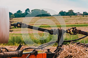 Tractor and cardan shaft for coupling equipment, tractor in the field during haymaking