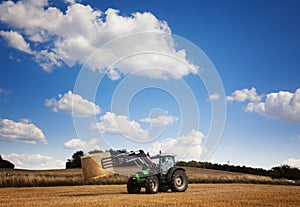 Tractor carrying hay at the field