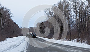 Tractor clean snow from the road. Russia. Chuiski