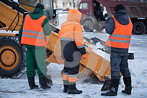 Tractor cleaning the road from the snow. Excavator cleans the streets of large amounts of snow