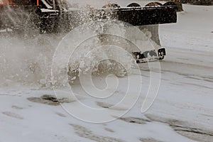 Tractor cleaning the road from the snow. Excavator cleans the streets of large amounts of snow in city.