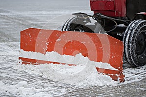 Tractor cleaning the road from the snow. Excavator cleans the streets of large amounts of snow in city.