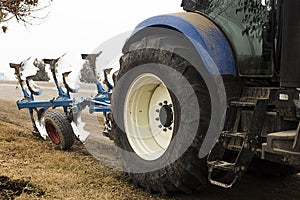 Tractor. Cropped image of modern farm equipment in field