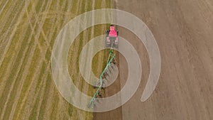 Tractor cultivates farmland with modern trailer plow