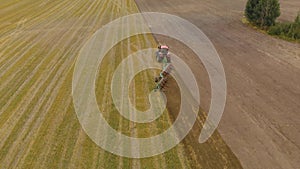 Tractor cultivates farmland with multi-body trailer plow