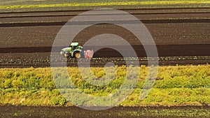 Tractor cultivates the land in the field.