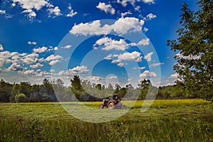 Tractor working on the field in a summer day