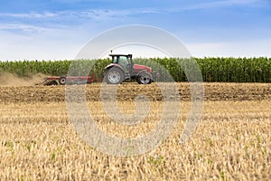 Tractor cultivating wheat stubble field, crop residue