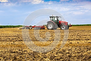 Tractor cultivating wheat stubble field, crop residue