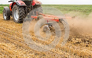 Tractor cultivating wheat stubble field, crop residue