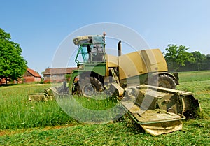 Tractor cutting grass meadow