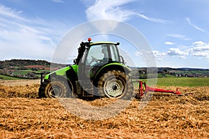 Tractor cutting hay