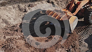 A tractor digs a hole at a construction site