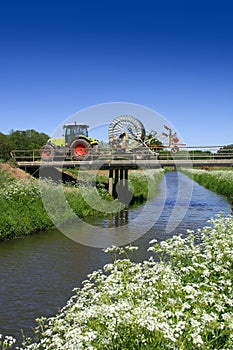 Tractor driving over bridge