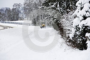 A tractor driving through the snow