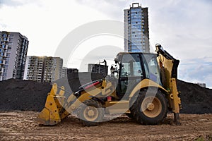 Tractor during excavation and road construction works at construction site. Wheel bulldozer loader during is underway to lay sewer