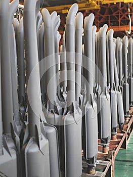 Tractor exhaust pipes at the factory workshop. Mufflers with exhaust pipes