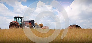 Tractor on farm landscape photo