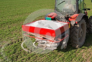 Tractor fertilizing in field