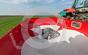Tractor fertilizing in field