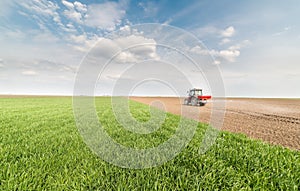 Tractor fertilizing in field