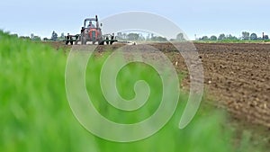 Tractor in a field of corn sowing