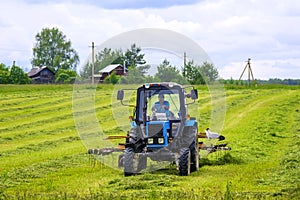 Tractor on the field. Hay making