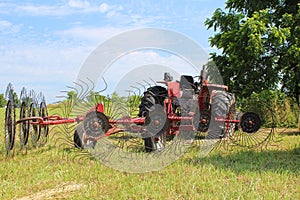 Tractor in Field with Hay Rake