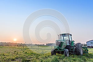 Tractor in a field on a Maryland farm at sunset