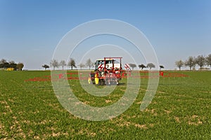 Tractor on field sputtering pest