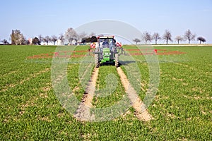 Tractor on field sputtering pest protection