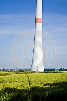 Tractor on a field with wind turbines in Bavaria, Germany