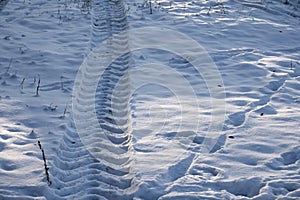 Tractor footprint snow Winter season. Abstract pattern.