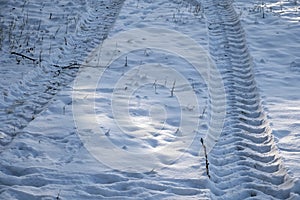 Tractor footprint snow Winter season. Abstract pattern.