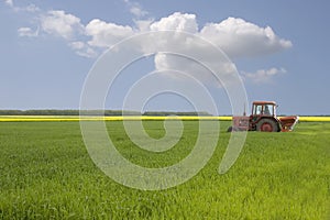 A tractor on the grass field with blue sky