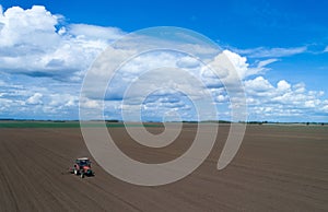 Tractor harrowing field photo
