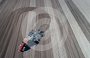 Tractor harrowing soil