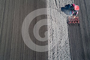 Tractor harrowing soil in spring