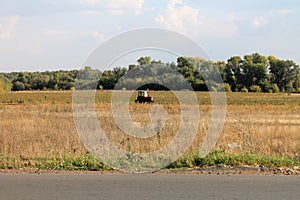 Tractor harvests. Agriculture. The harvest season.