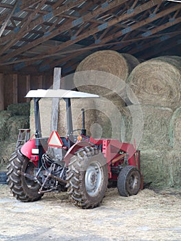 Tractor by the hay bails photo