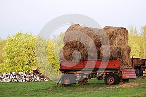 A tractor with hay bales in Russian countryside
