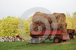 A tractor with hay bales in Russian countryside