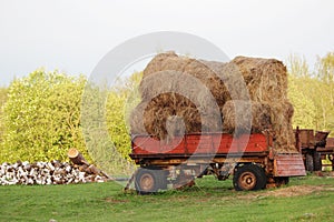 A tractor with hay bales in Russian countryside