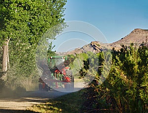 Tractor and Hay Rake on Dusty Road