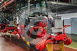 Tractor industry manufacture. New tractors on factory line. Production of agricultural machinery