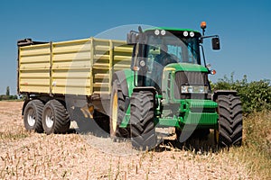 Tractor John Deere on harvested field